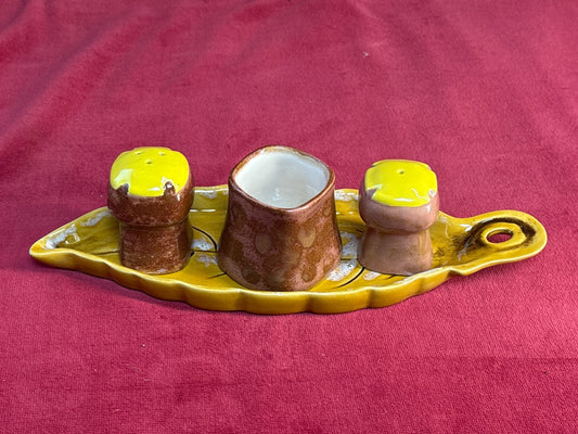 Service à condiments en céramique jaune et brune sur plateau feuille